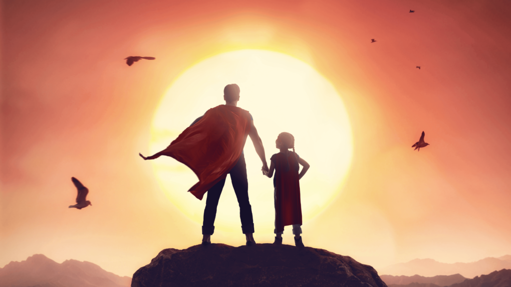 Parent and child superheroes standing in front of the sun.